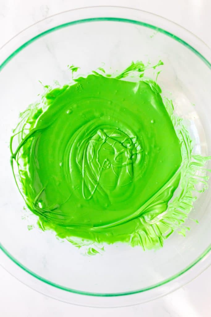 melted green chocolate in a glass mixing bowl