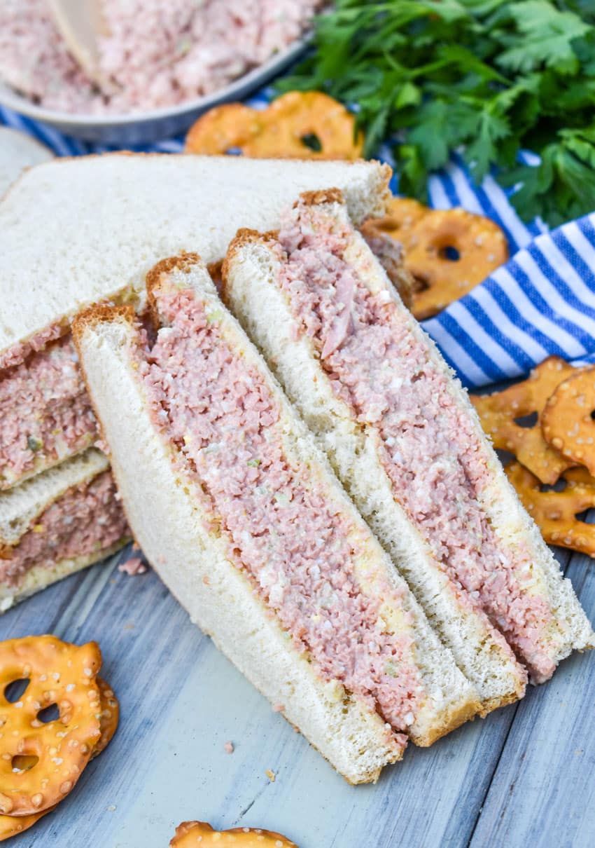 halved bologna salad sandwiches on white bread