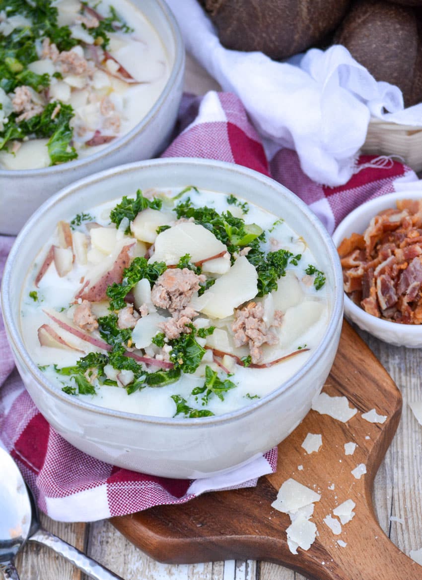 a gray bowl filled with copycat olive garden zuppa toscana soup