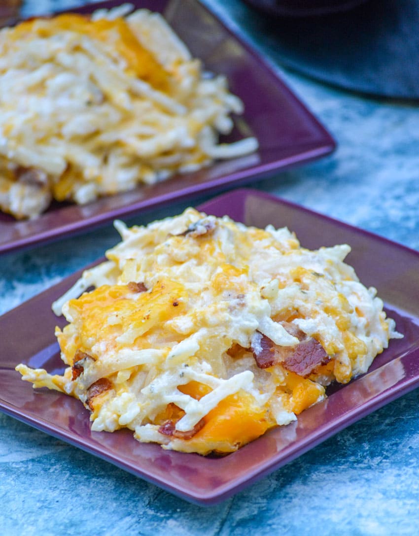 Slow cooker cheddar bacon ranch hash browns on a square purple plate