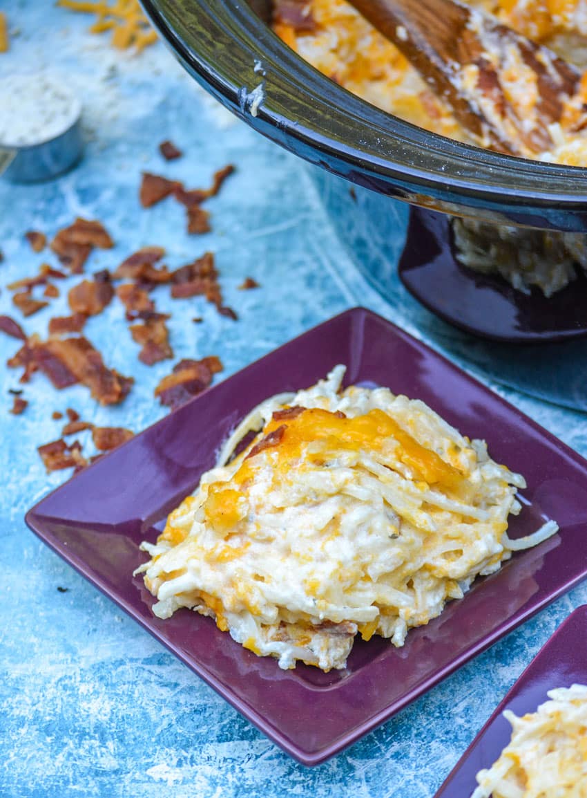 cheesy crack hash browns on a square purple plate