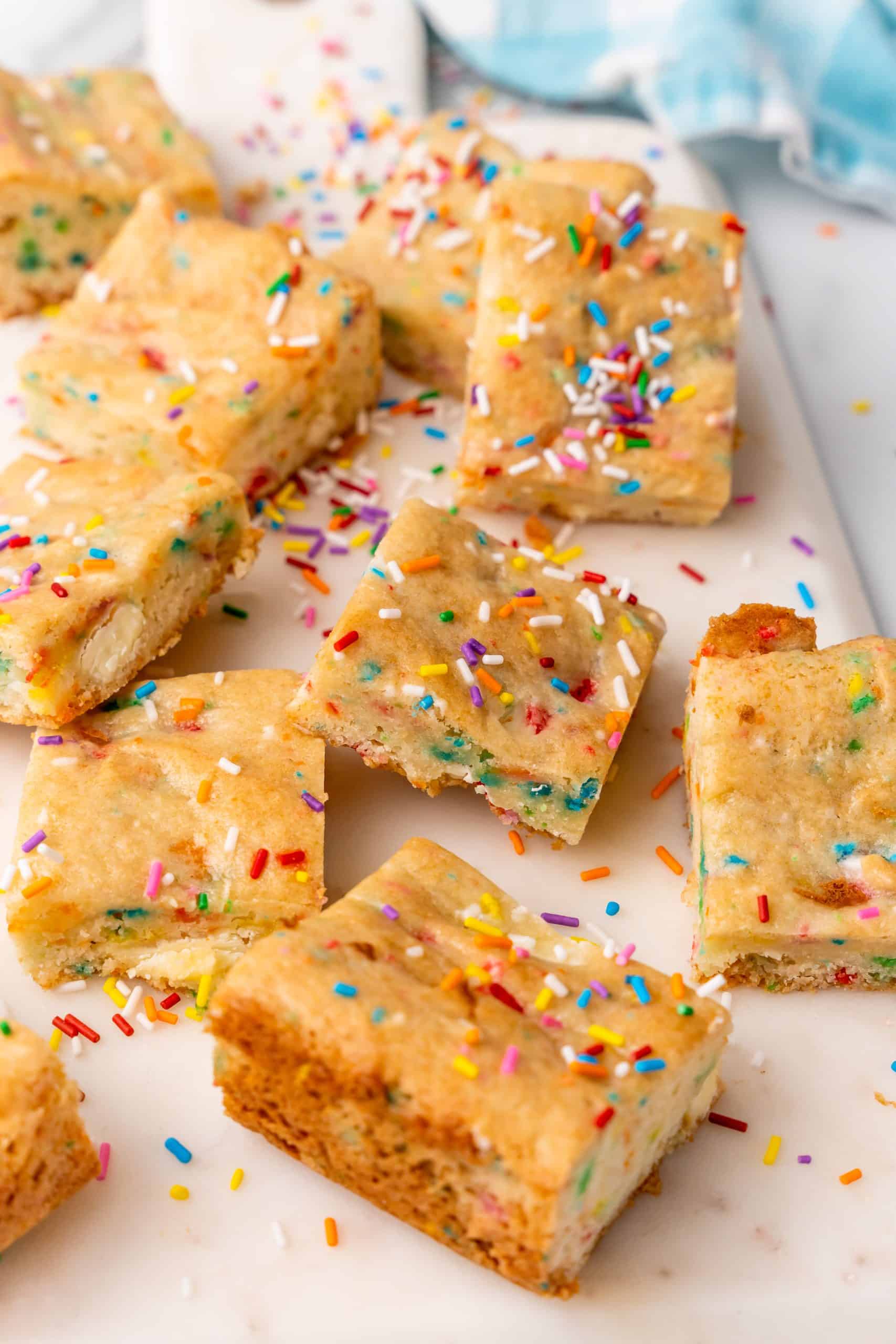 cake batter blondies on a white cutting board