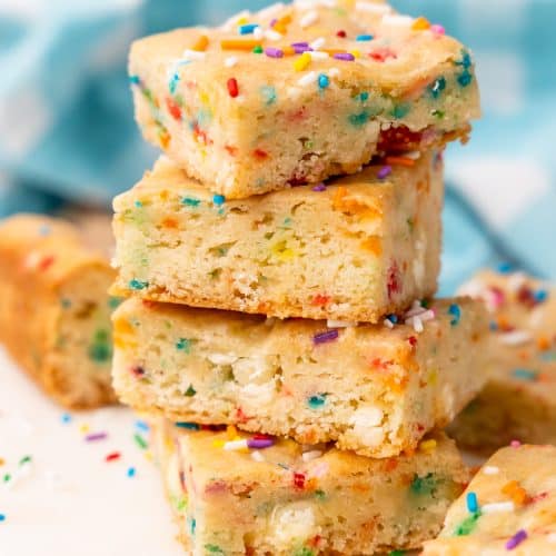 four birthday cake blondies stacked on top of each other