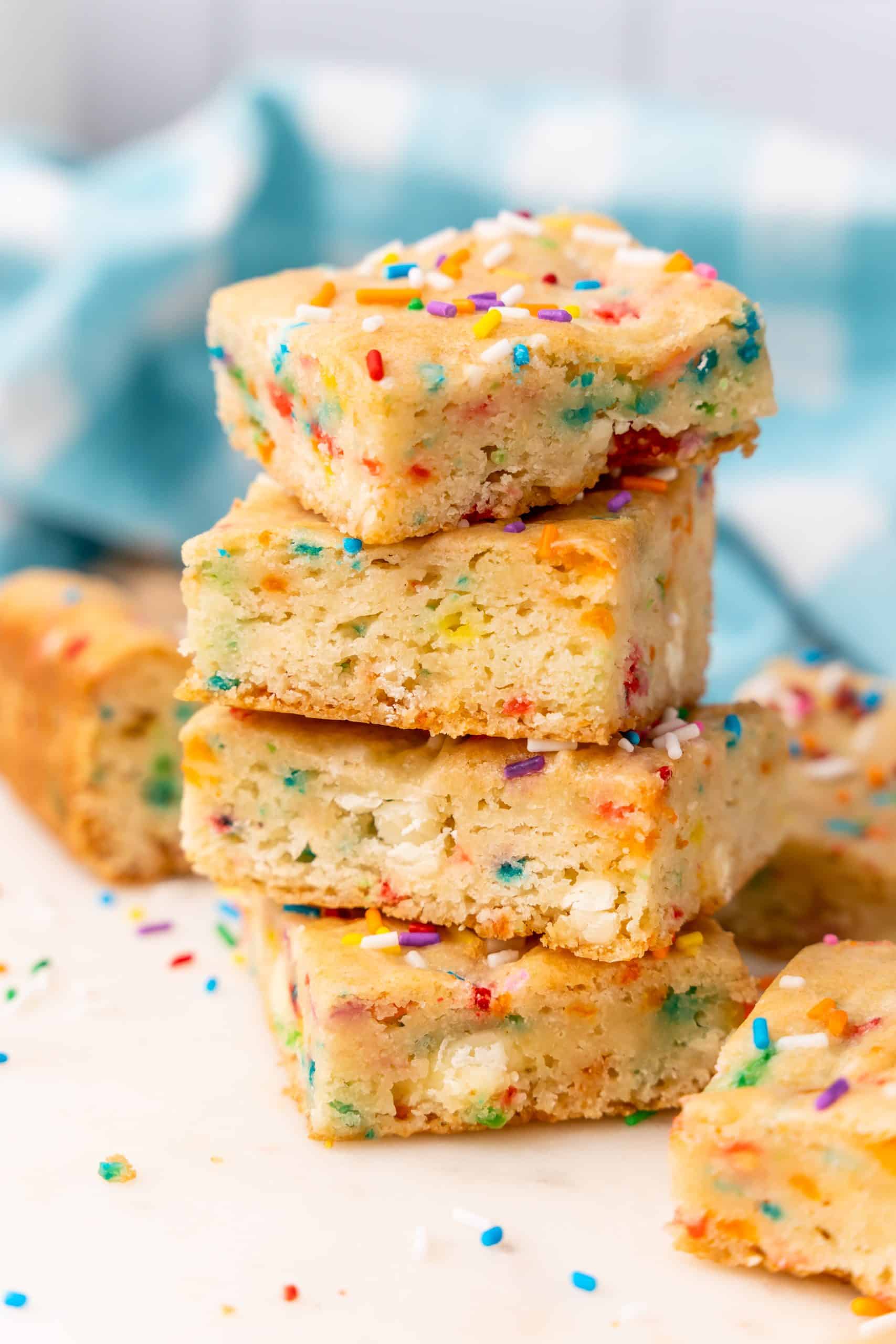 four birthday cake blondies stacked on top of each other