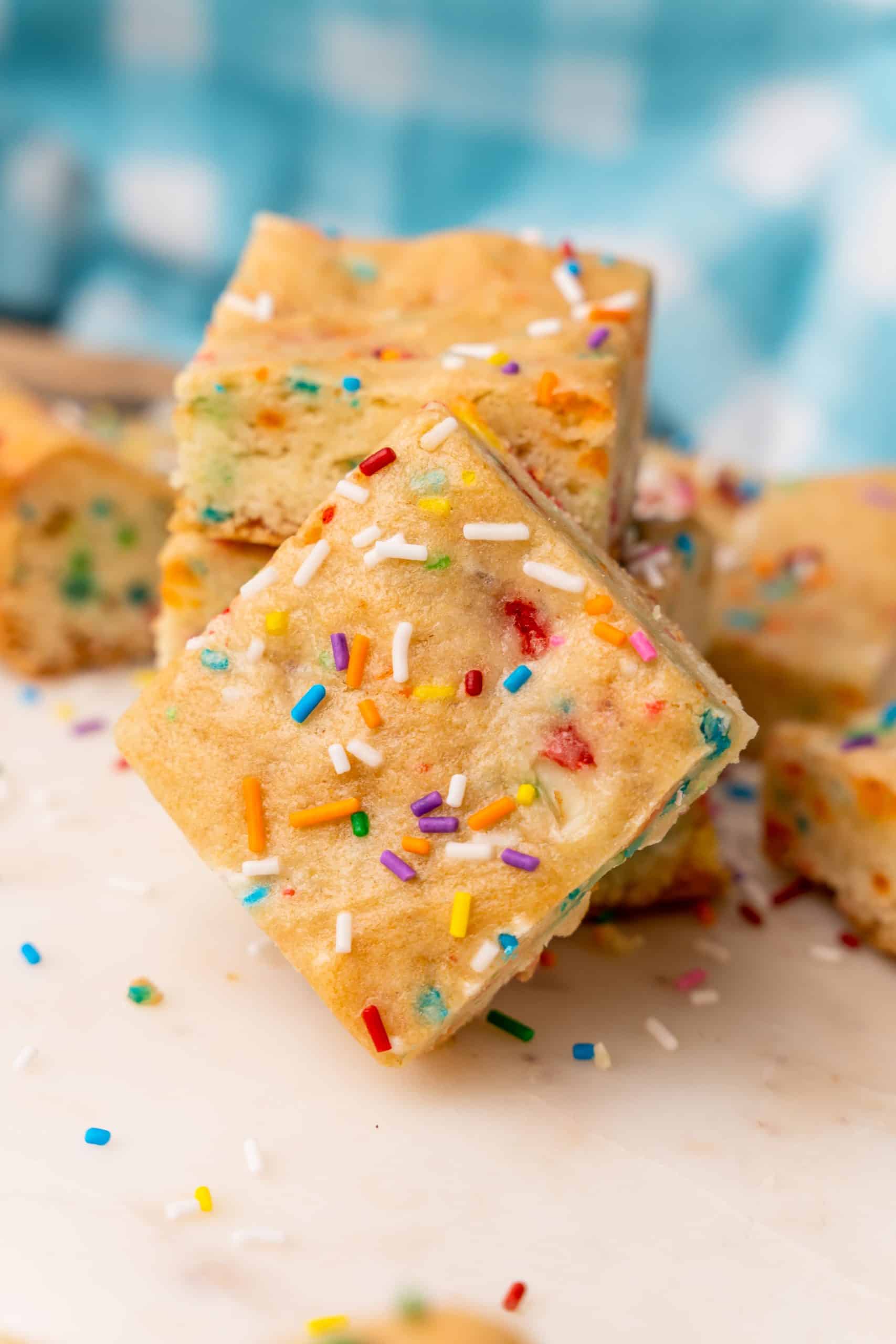 funfetti cake mix cookie bars on a white cutting board