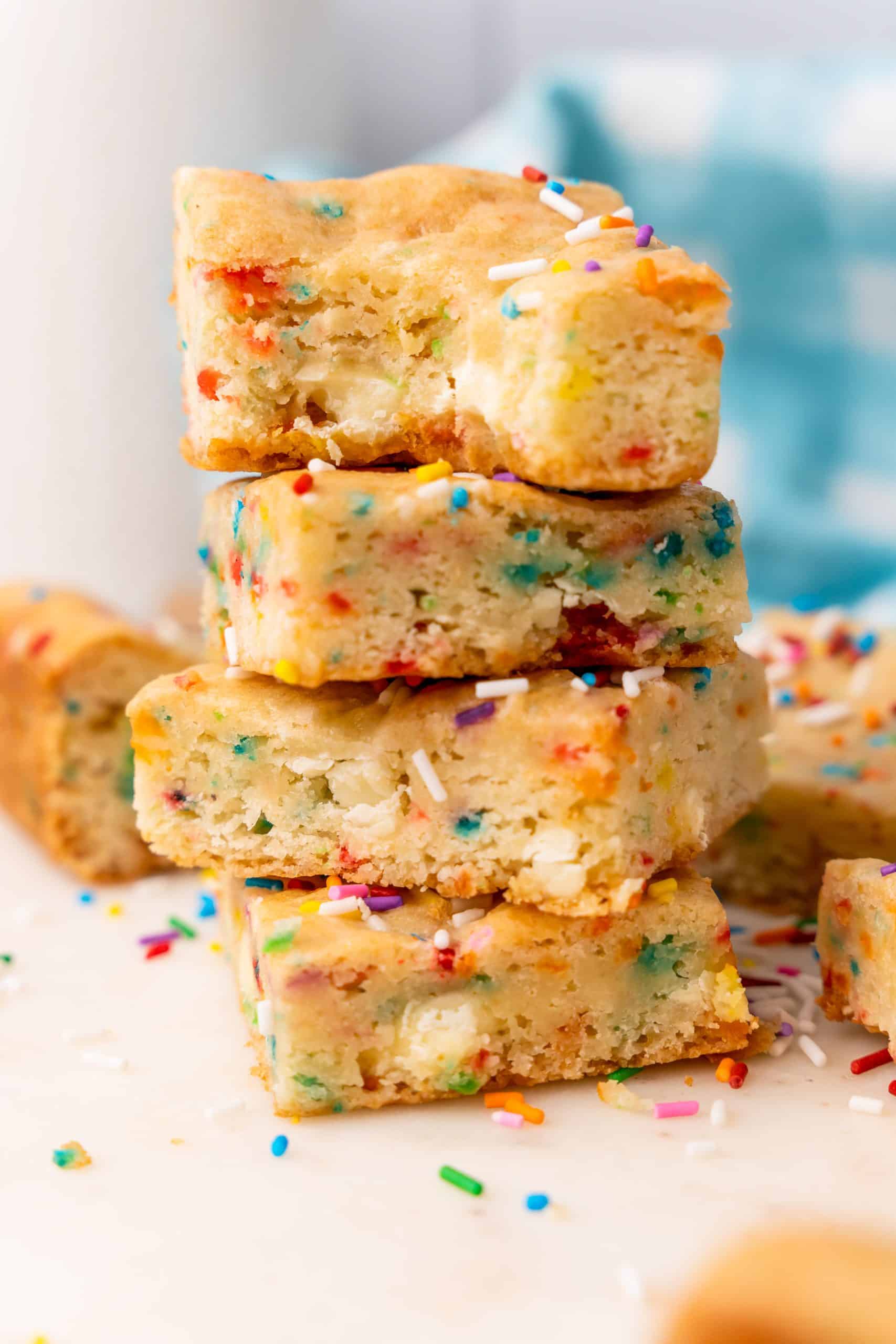 a stack of cake mix cookie bars on a white cutting board
