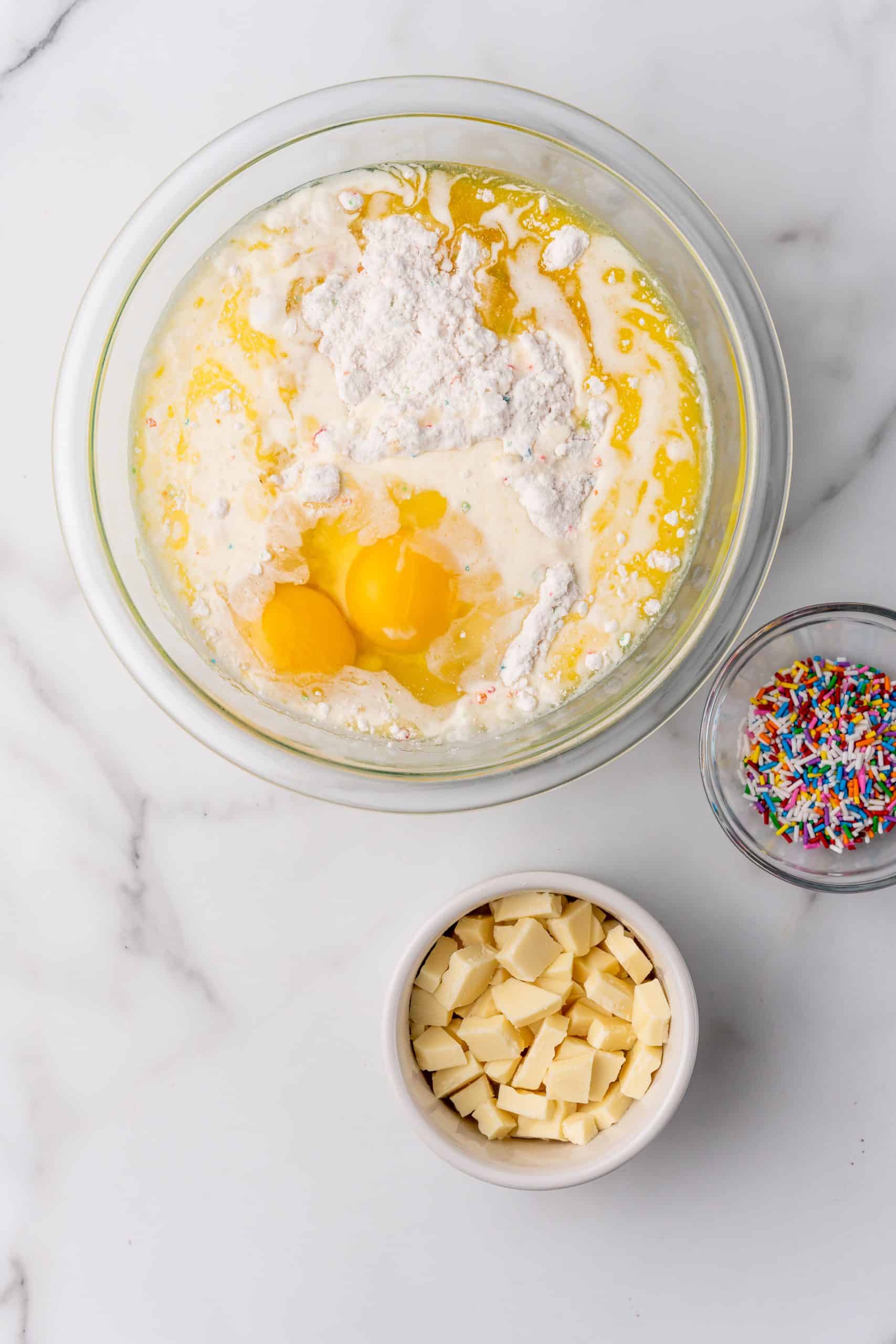 cake mix batter ingredients in a glass mixing bowl