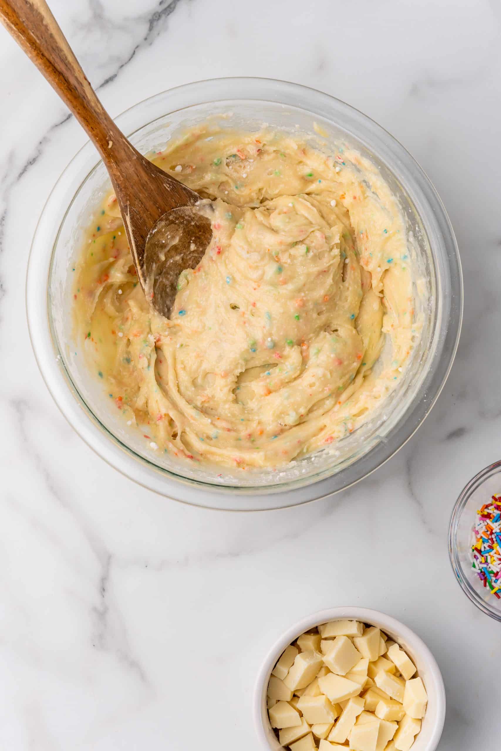 funfetti cake mix batter in a glass mixing bowl