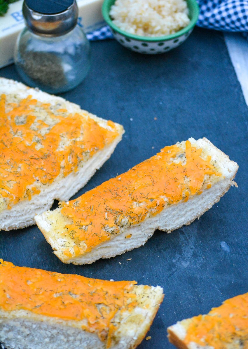 slices of cheesy ranch bread on a slate cutting board