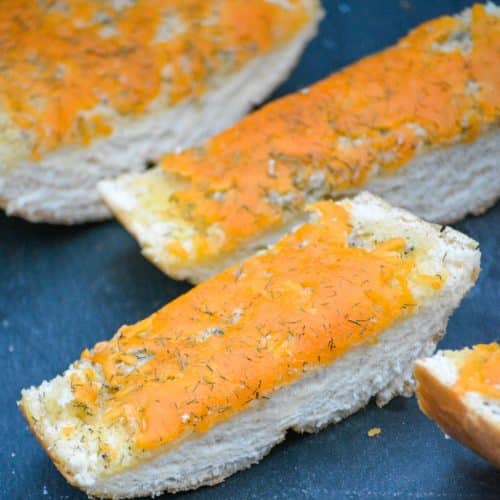 slices of cheesy ranch bread on a slate cutting board
