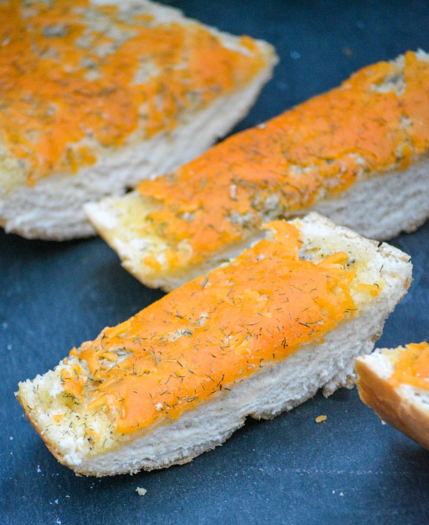 slices of cheesy ranch bread on a slate cutting board