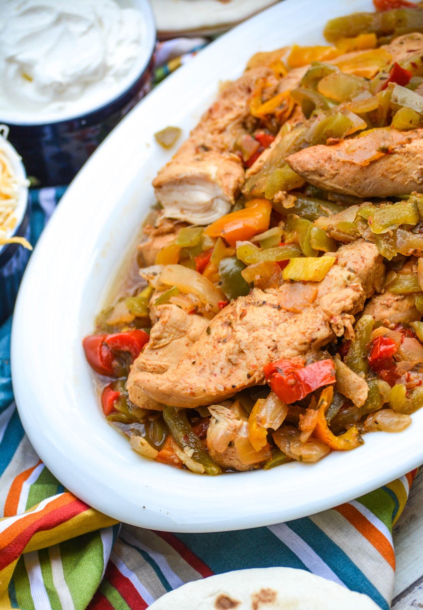 slow cooker chicken fajitas in a white serving bowl