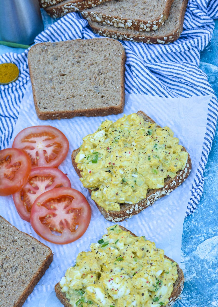 curried egg salad piled on two pieces of fluffy wheat bread