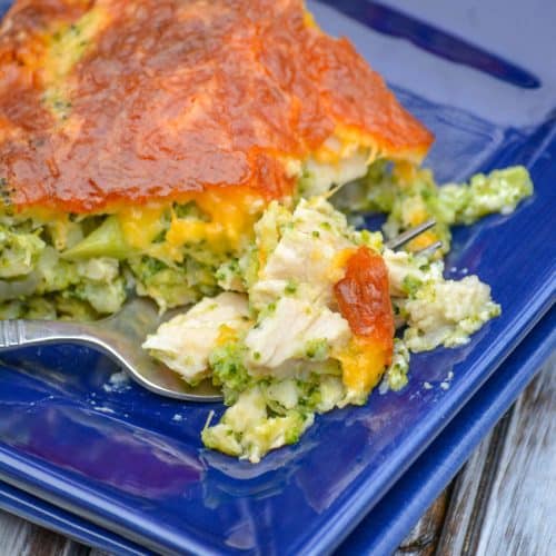 a slice of cheesy chicken and broccoli pie on a blue plate