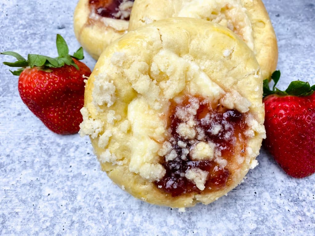 homemade strawberry cream cheese danishes next to fresh berries