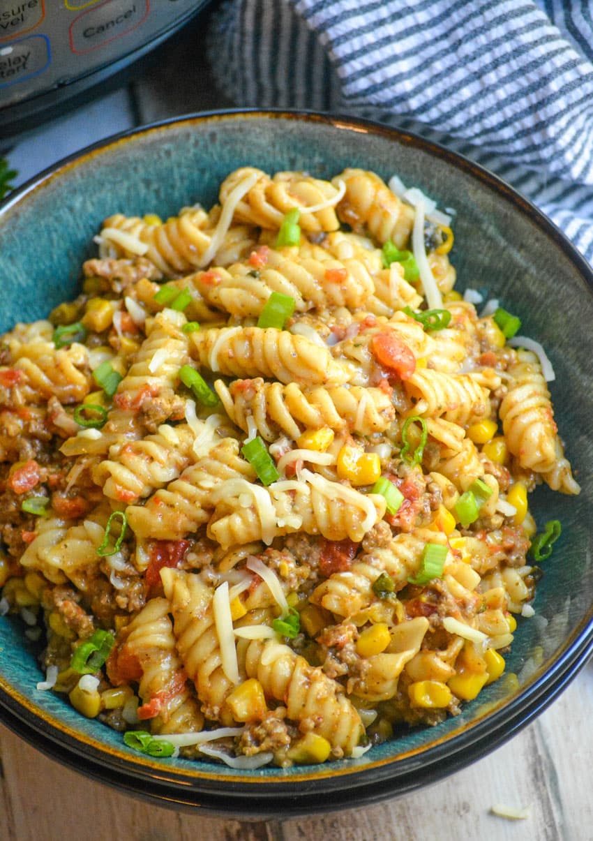 cheesy Instant Pot taco pasta  in a blue bowl