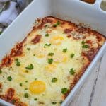 Italian baked eggs in a white casserole dish