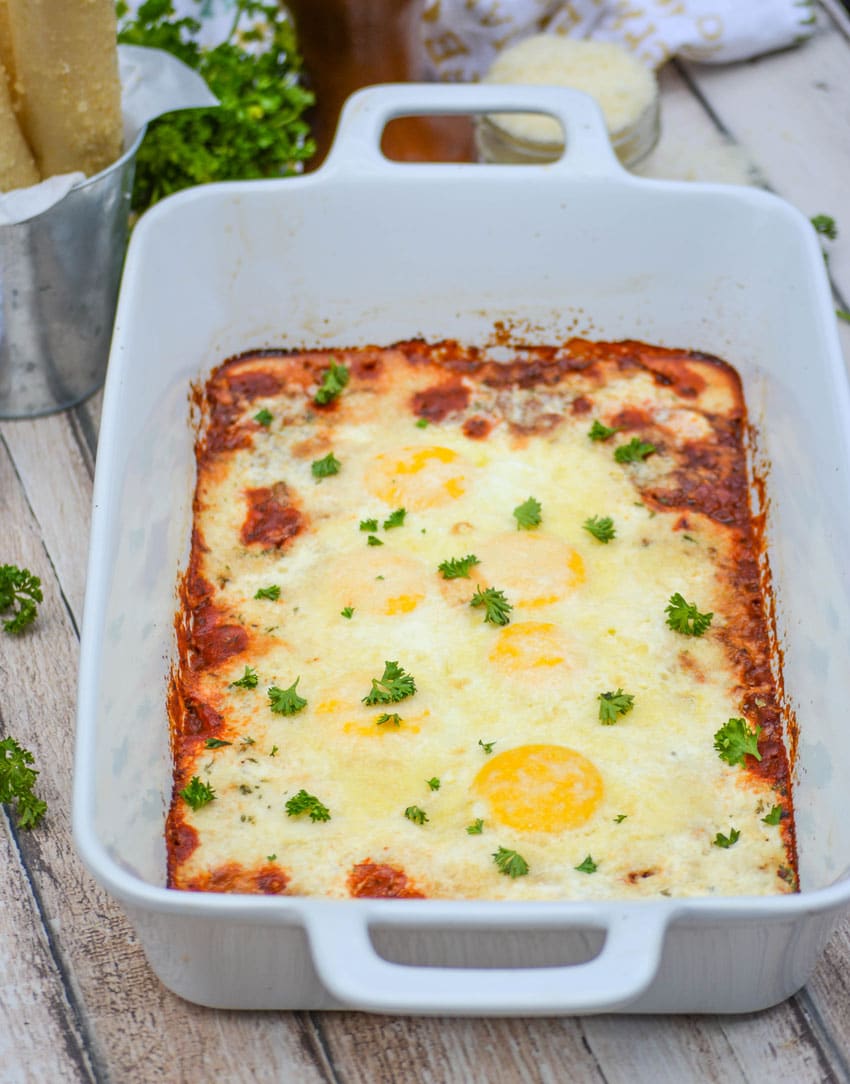 Italian baked eggs in a white casserole dish
