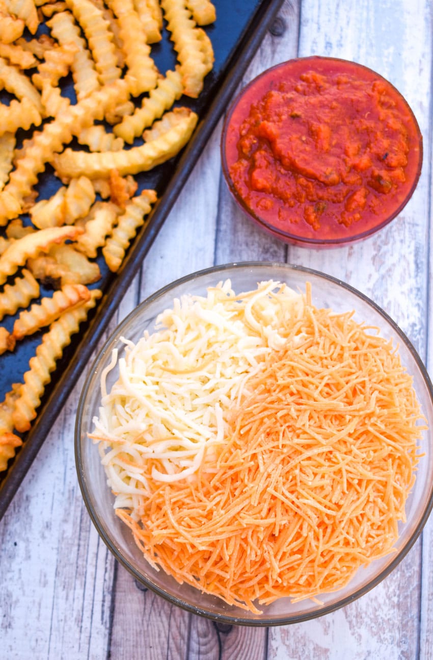 an overhead image showing the measured ingredients needed to make a batch of cheesy pizza fries