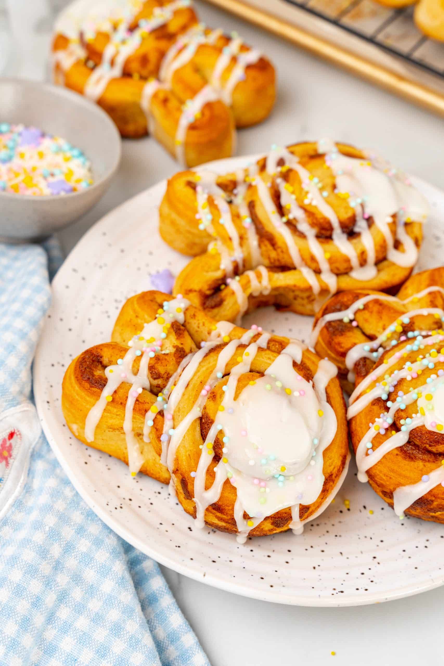 Easter bunny cinnamon buns on a white speckled plate