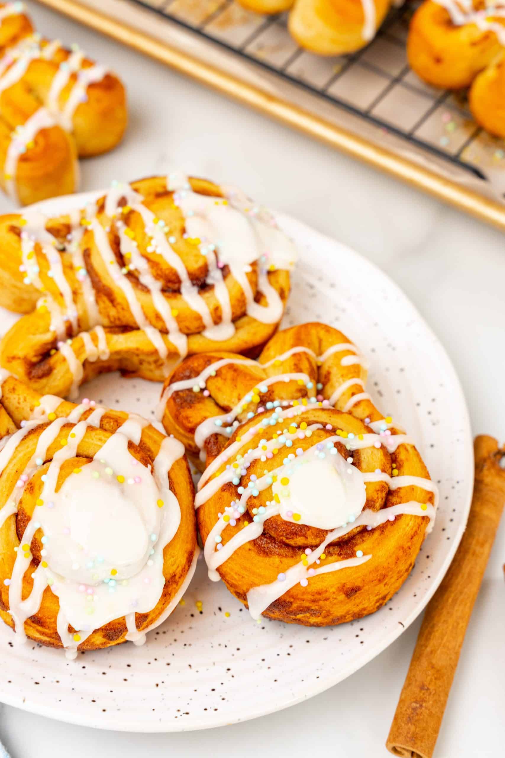 Easter bunny cinnamon buns on a white speckled plate