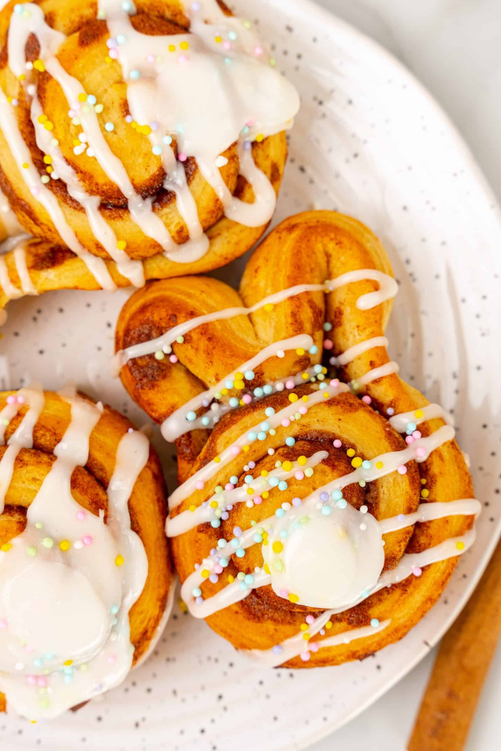 Easter bunny cinnamon buns on a white speckled plate