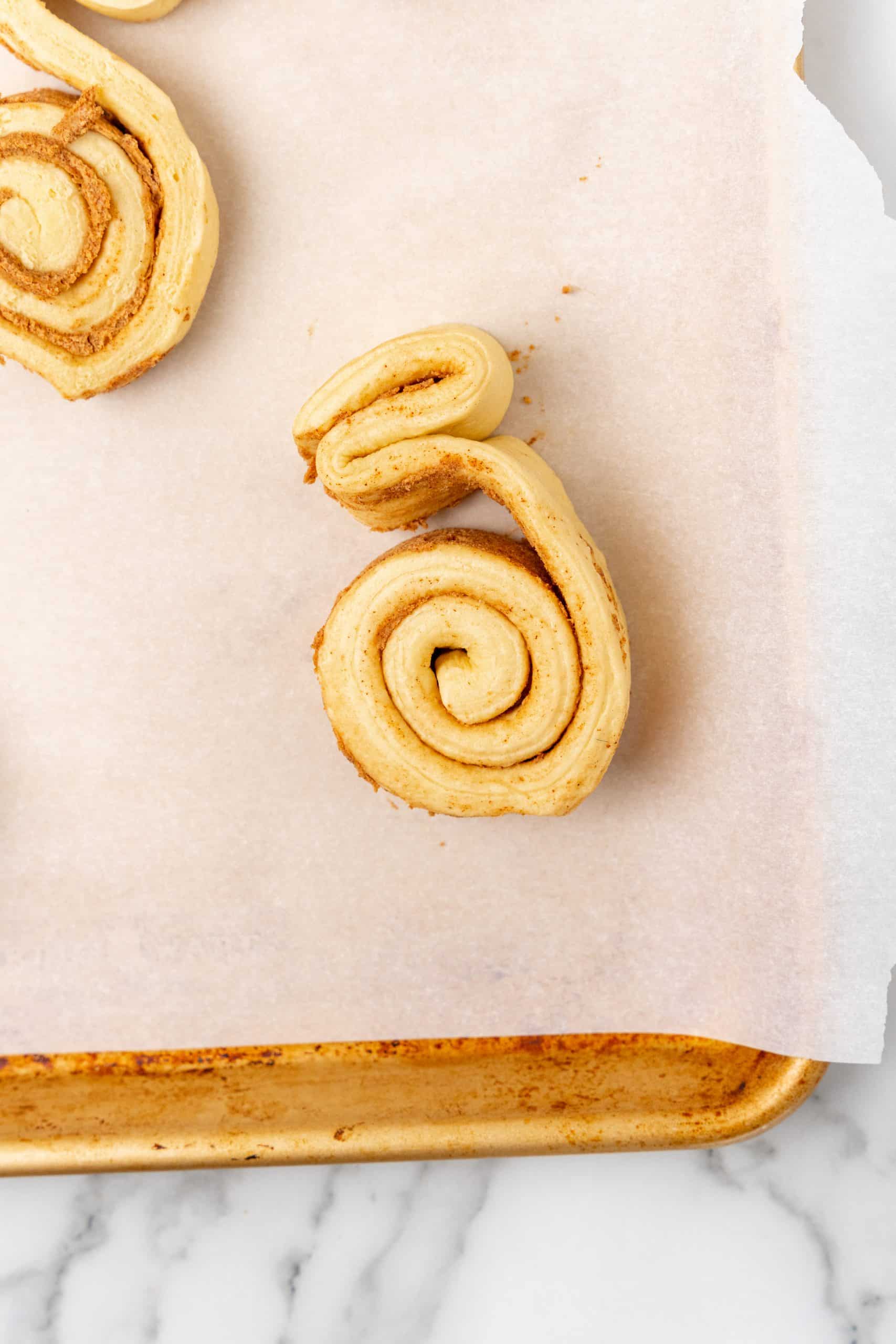 spread apart canned cinnamon rolls on a parchment paper lined baking sheet