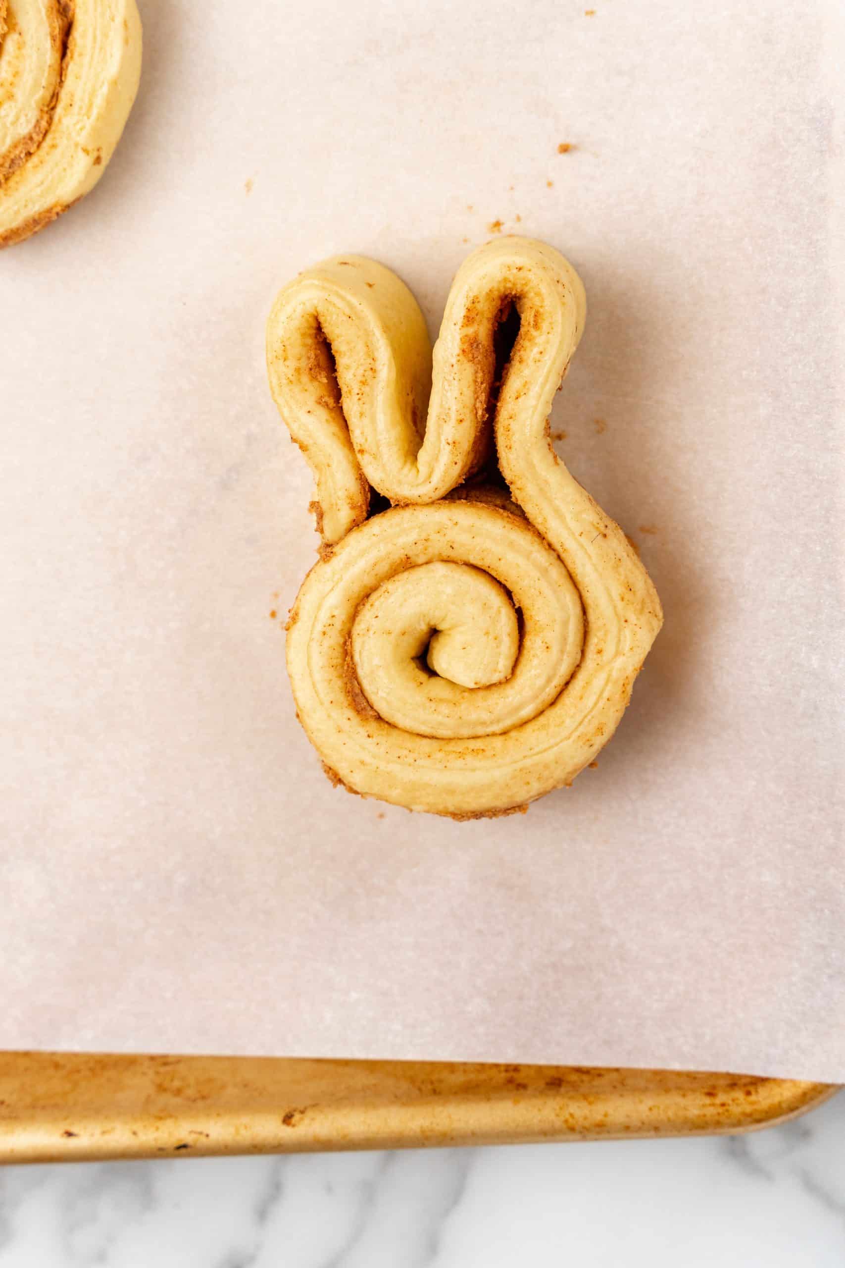 Easter bunny cinnamon rolls on parchment paper