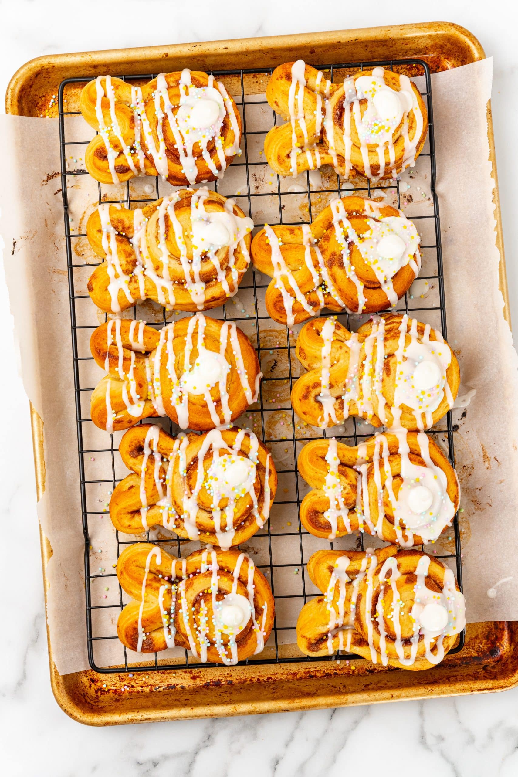 frosted bunny cinnamon rolls on a wire cooling rack