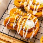 frosted bunny cinnamon rolls on a wire cooling rack
