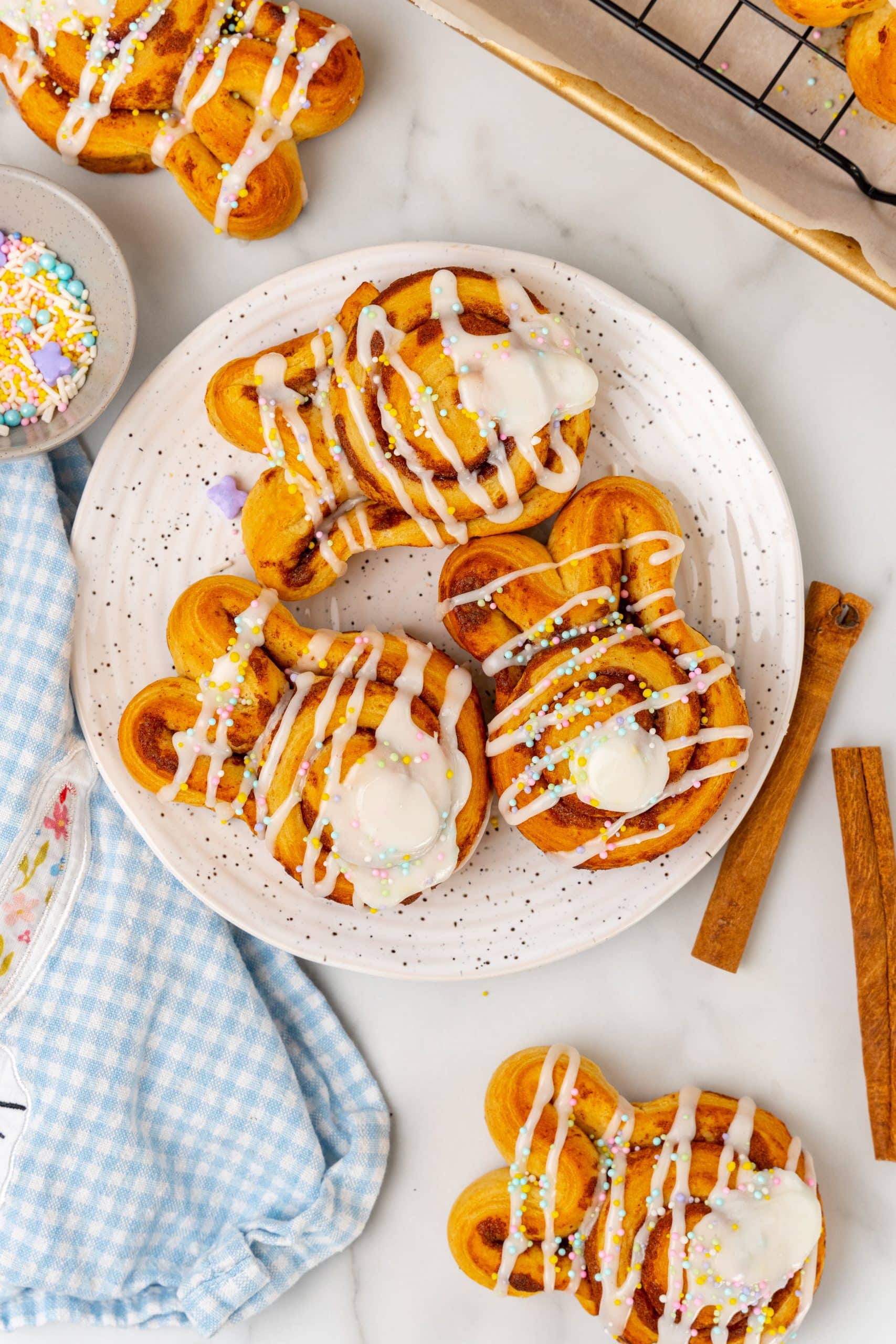 Easter bunny cinnamon buns on a white speckled plate