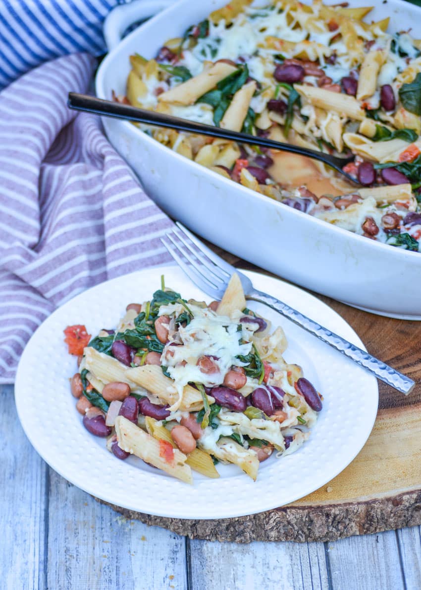 pasta e fagioli bake on a small white plate with a silver fork on the side