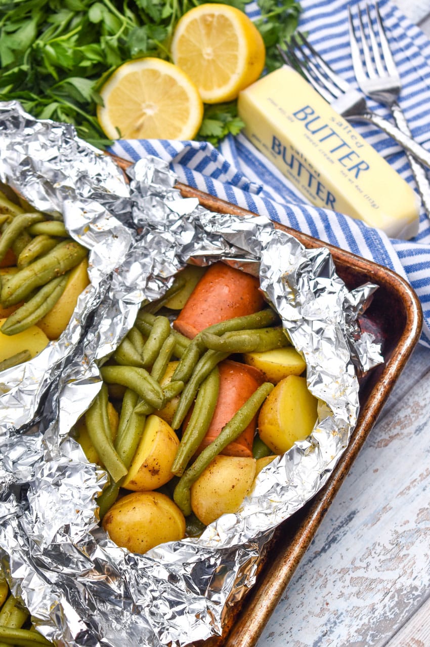 opened Cajun chicken foil packets on a metal baking sheets