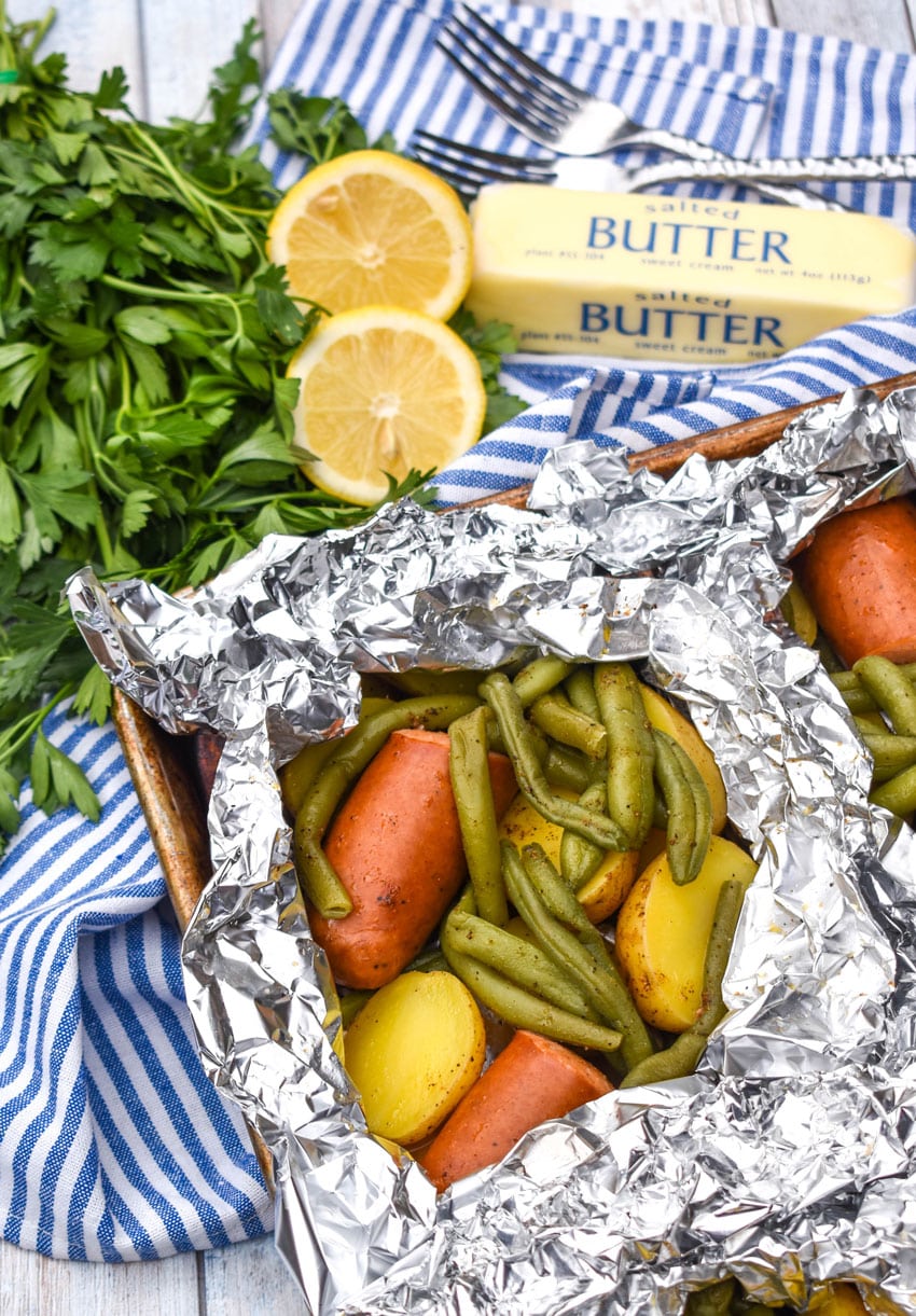 opened Cajun chicken foil packets on a metal baking sheets