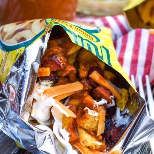 a bag of chili cheese dog walking taco opened on a wooden table