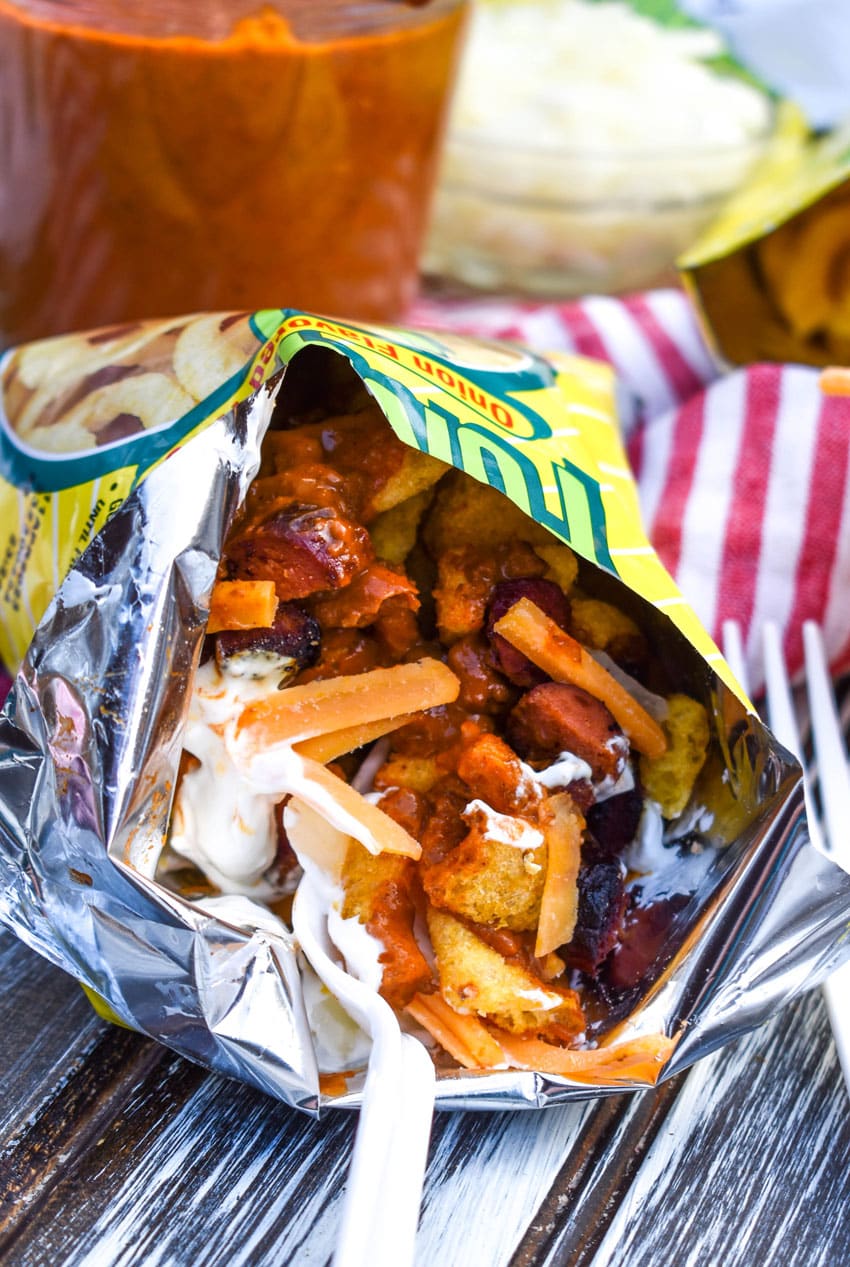 a bag of chili cheese dog walking taco opened on a wooden table