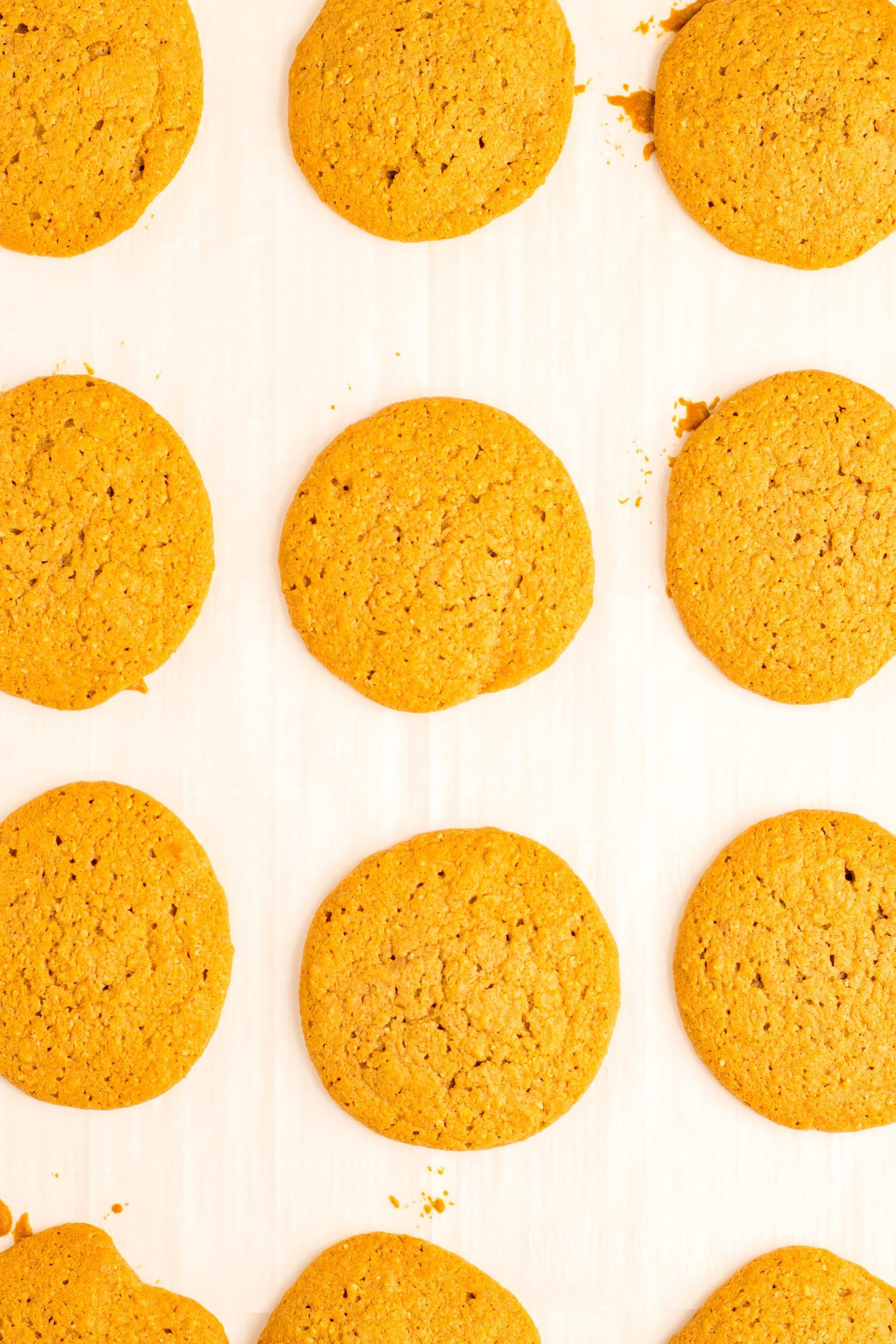 baked oatmeal creme pie cookie halves cooling on parchment paper