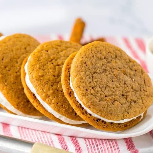 homemade oatmeal cream pies lined up on a white rectangular serving platter