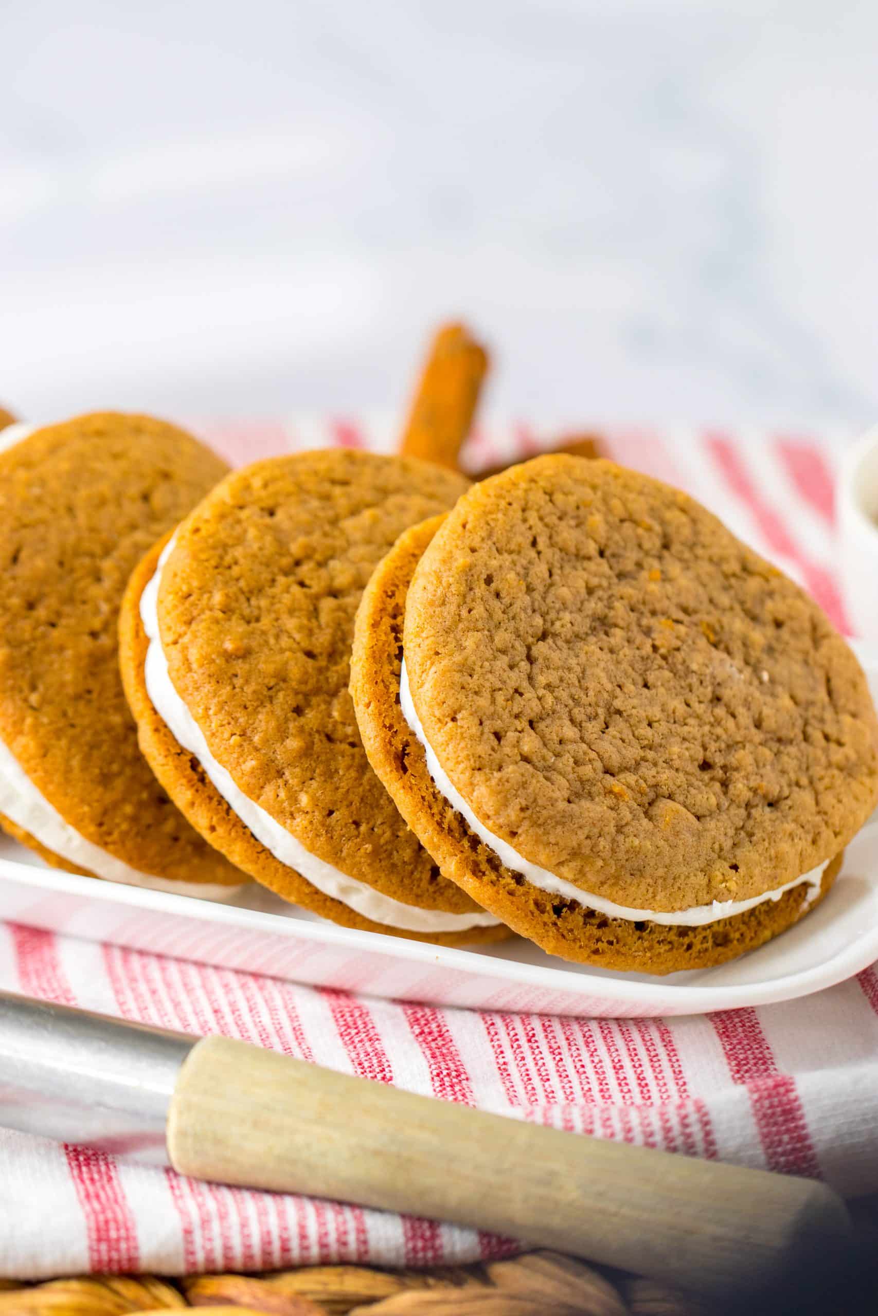 Homemade Oatmeal Creme Pies (Little Debbie Copycat) homemade oatmeal cream pies lined up on a white rectangular serving platter