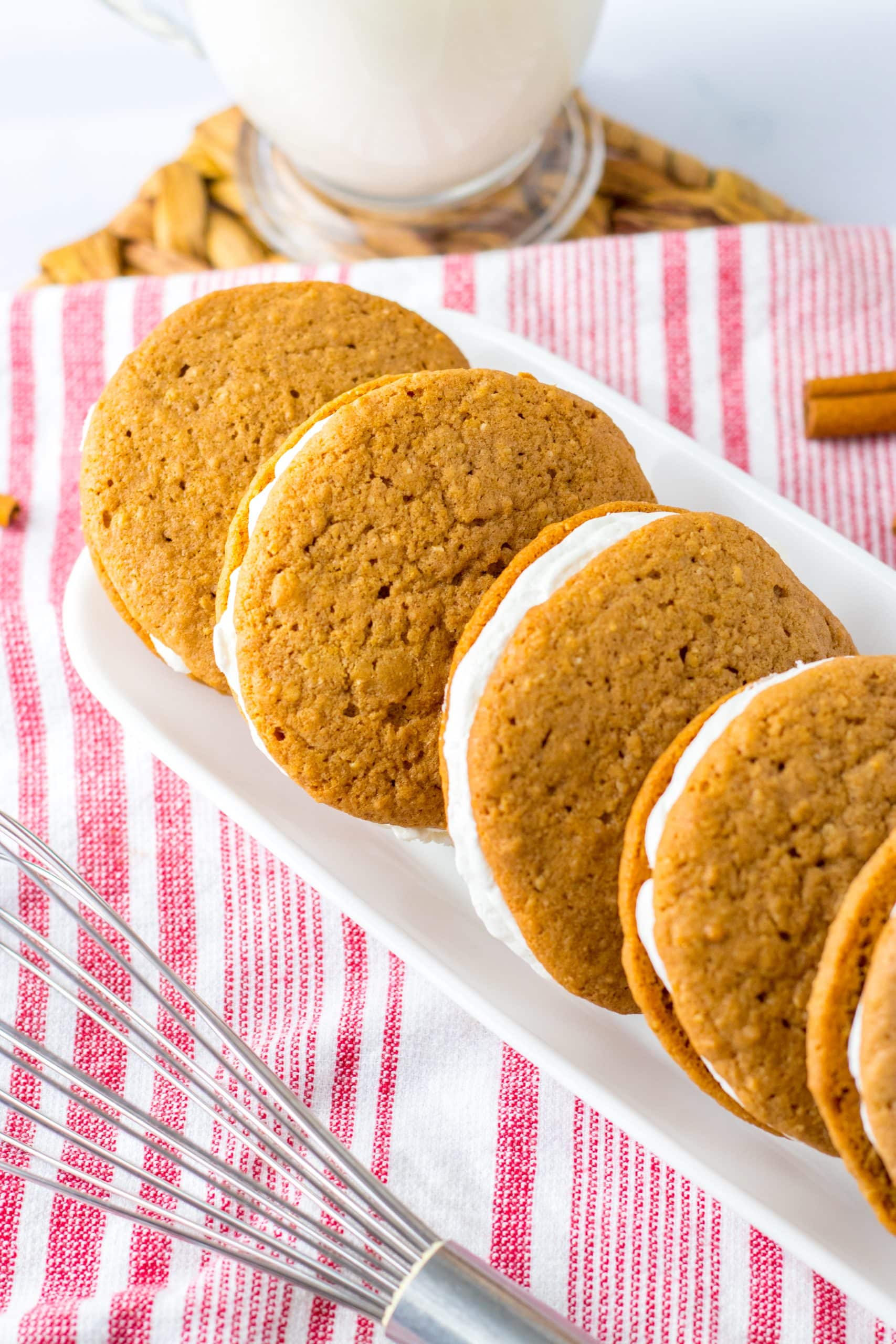 homemade oatmeal cream pies lined up on a white rectangular serving platter