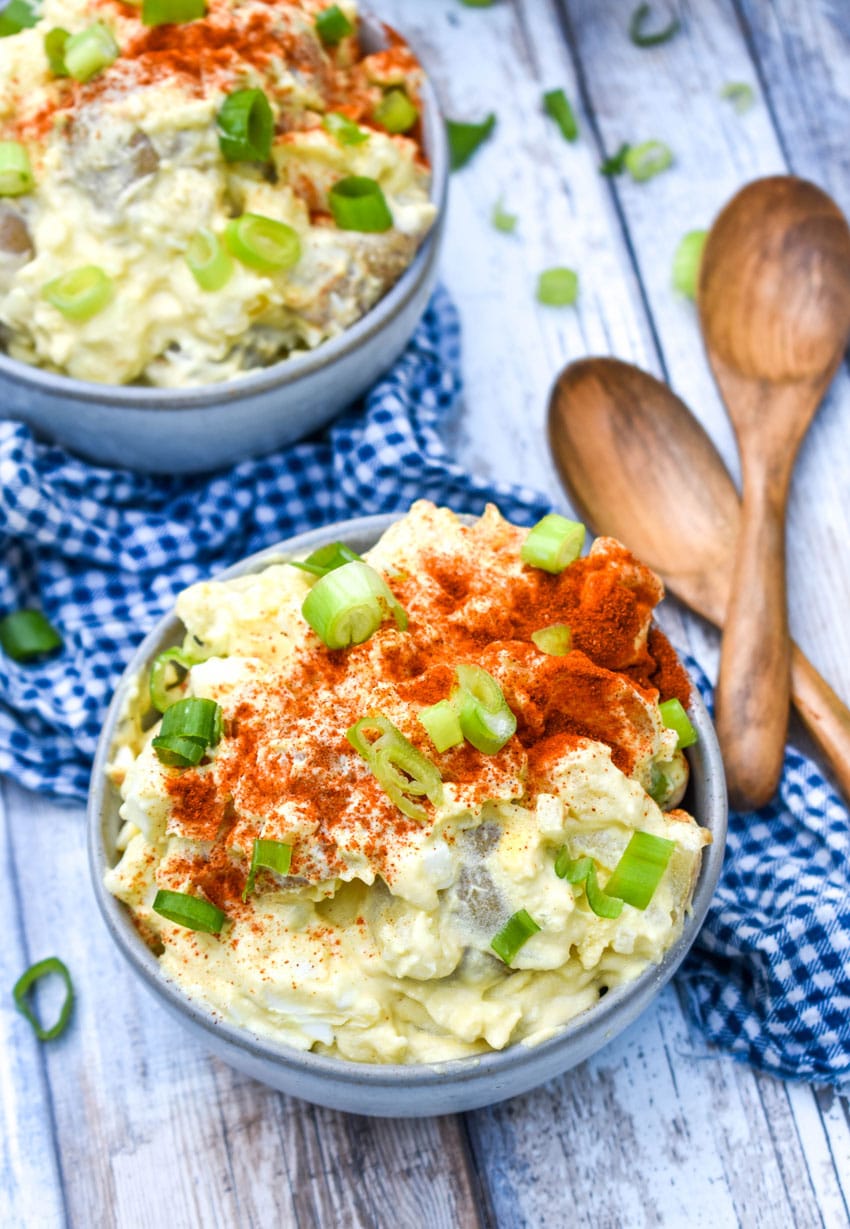 creamy potato salad recipe with egg served in two small gray bowls