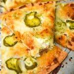 dill pickle pizza on a metal pizza pan