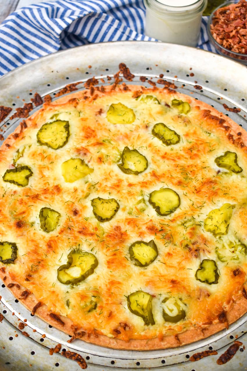 dill pickle pizza on a metal pizza pan