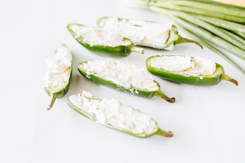cream cheese filled jalapeno halves on a white countertop