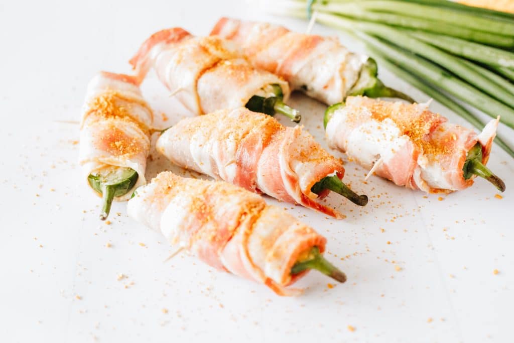 bacon wrapped jalapeno poppers on a white counter top