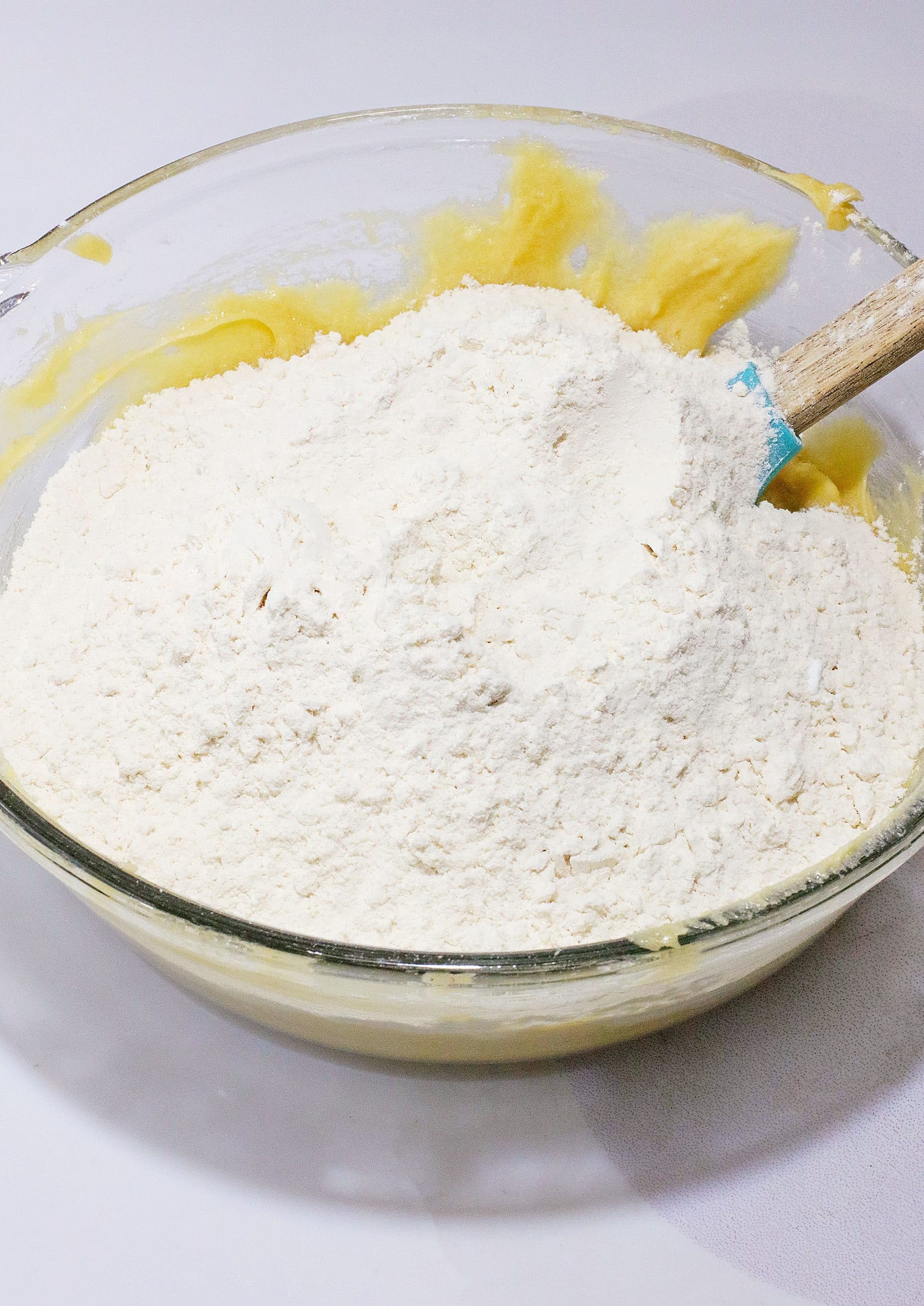 dry ingredients for a cookie cake in a glass mixing bowl