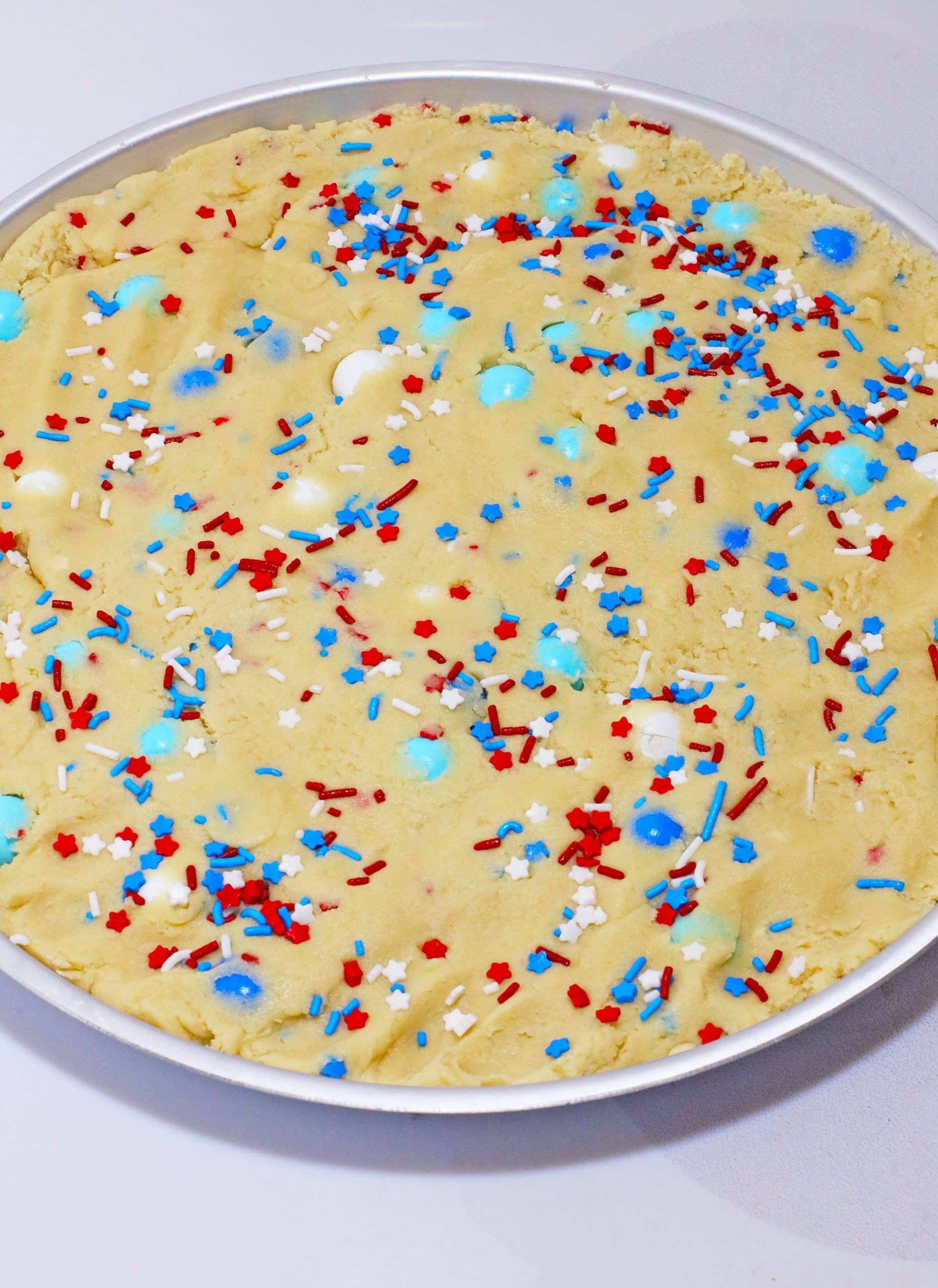 cookie pie dough spread out in a small pie pan