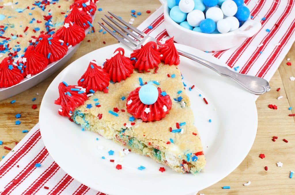 red white and blue frosted cookie cake on a white plate