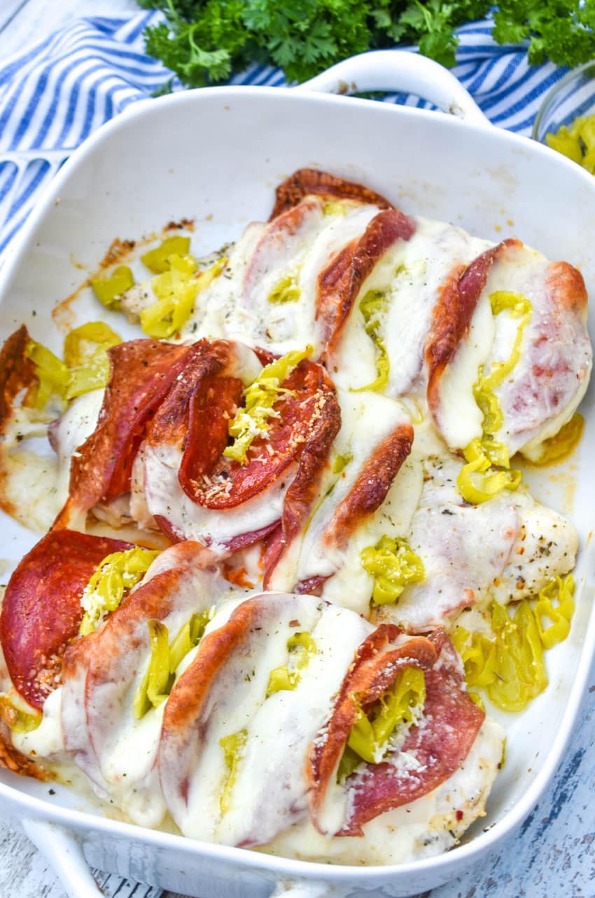 Antipasto hasselback chicken breasts in a white baking dish
