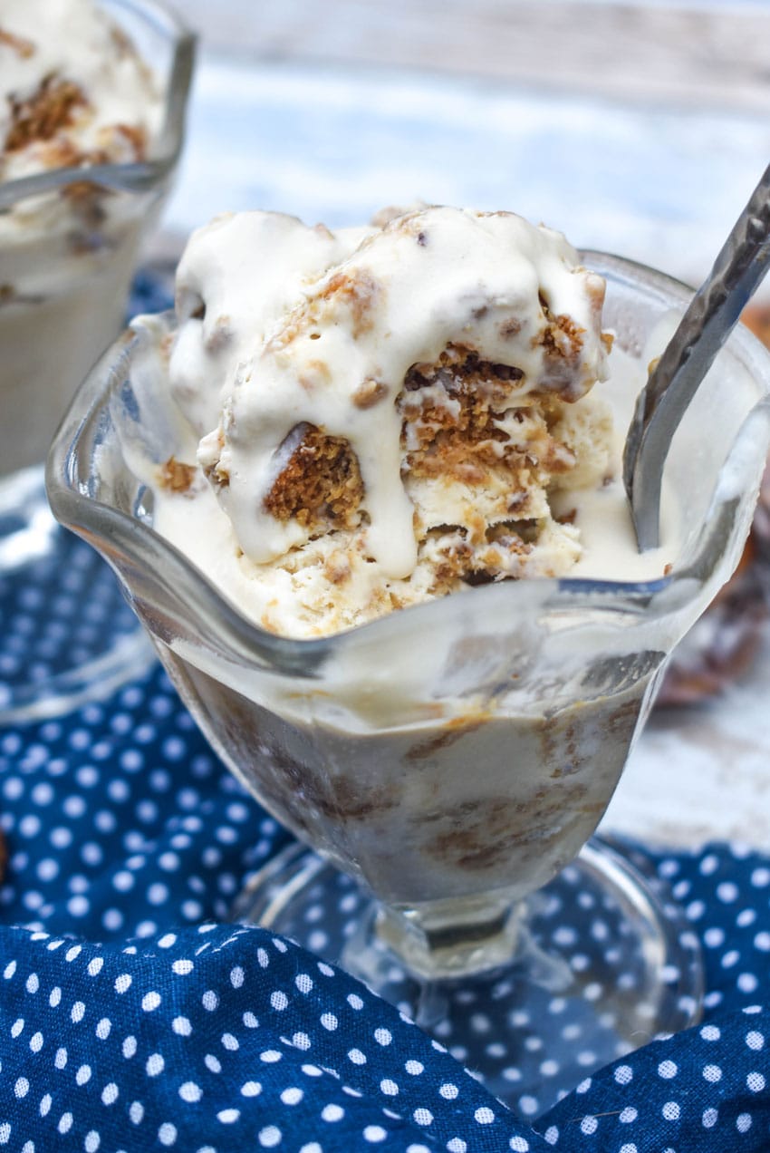 a spoon sticking out of a glass dish filled with melting copycat little debbie oatmeal cream pie ice cream